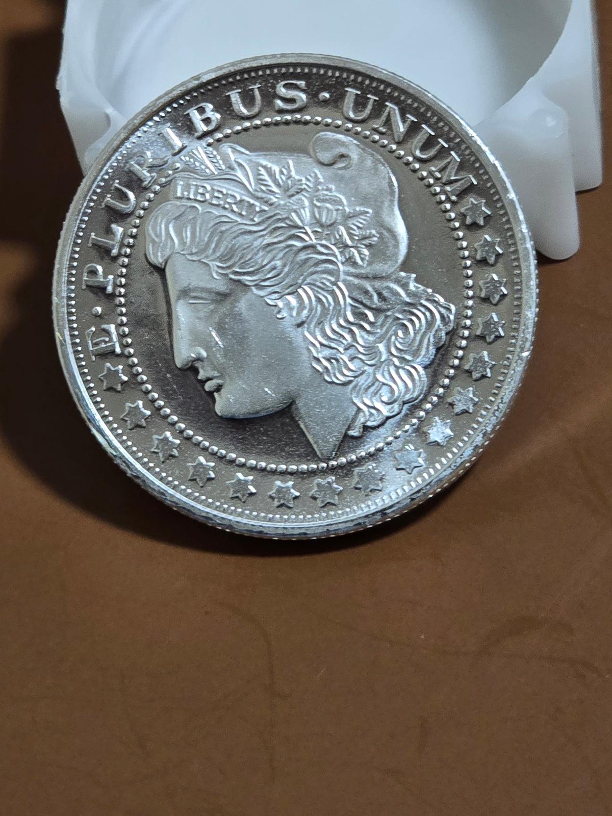 1oz silver Morgan round without capsule